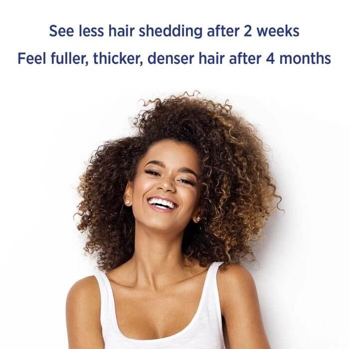 Smiling woman with full afro hair – saw less shedding in 2 weeks and fuller, thicker hair after 4 months with MD Nutri Hair

